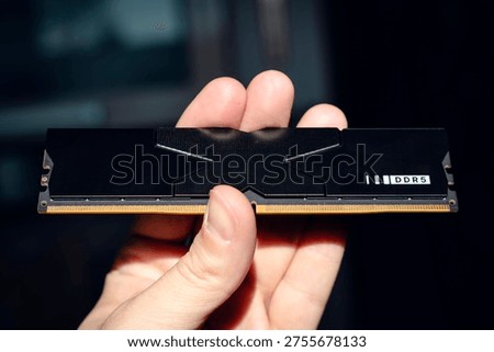 Fast DDR5 memory module held in hand.