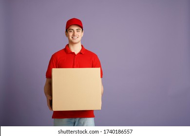 Fast Delivery And Big Parcel. Caucasian Post Worker Gives Out Big Box, Isolated On Gray Background, Studio Shot