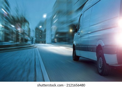 Fast delivery truck driving in the city at night