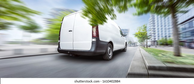 Fast driving delivery van inside a city