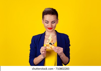 Fast Fat Food Love. Closeup Portrait Young Eager Greedy Confused Woman Holding Looking At Fatty Pizza Craving Junk Food Trying To Resist Temptation To Eat Isolated Yellow Background. Face Expression