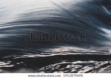 Fast flowing cold water mountain stream, flowing stream stream with flat smooth surface, nature outdoors, fresh stream dark blue water, clean environment