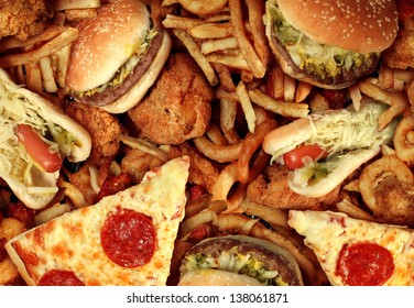 Fast food concept with greasy fried restaurant take out as onion rings burger and hot dogs with fried chicken french fries and pizza as a symbol of diet temptation resulting in unhealthy nutrition. - Shutterstock ID 138061871