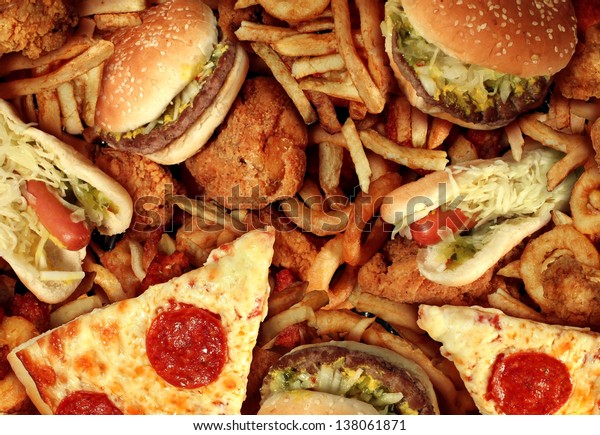 Fast food concept with greasy fried restaurant\
take out as onion rings burger and hot dogs with fried chicken\
french fries and pizza as a symbol of diet temptation resulting in\
unhealthy nutrition.