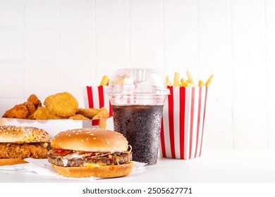 Fast food delivery menu background with various burgers, cheeseburger, nuggets, french fries, fizzy soda drinks. Junk unhealthy fast food, Ultra processed food with low nutrition, high calories value - Powered by Shutterstock