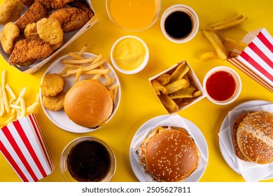 Fast food delivery menu background with various burgers, cheeseburger, nuggets, french fries, fizzy soda drinks. Junk unhealthy fast food, Ultra processed food with low nutrition, high calories value - Powered by Shutterstock