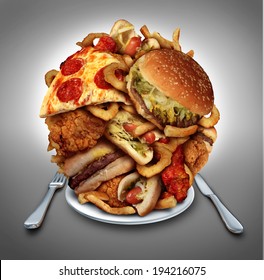 Fast food diet concept served on a plate of greasy fried take out as onion rings burger and hot dogs with fried chicken french fries and pizza as a symbol of compulsive overeating and dieting.