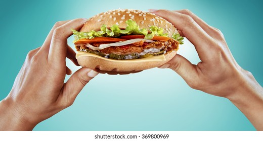 Fast food and diet. Hands hold the hamburger 