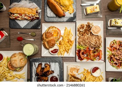 Fast Food Dishes With Basmati Rice With Squid, Hot Dogs, Assorted Burgers, Sandwich With Sauce And Fries, Desserts And Cakes, Barbecue Wings