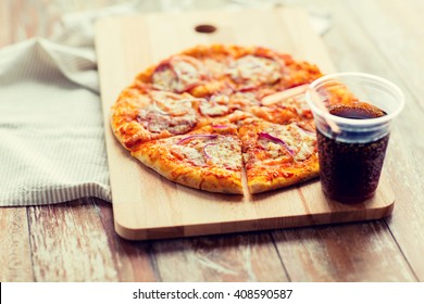 Fast Food, Italian Kitchen And Eating Concept - Close Up Of Pizza With Cup Of Cola Drink On Wooden Table