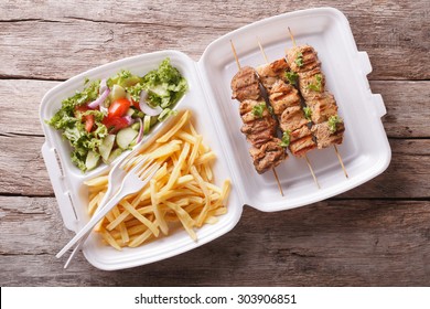 Fast Food: Kebabs, Fries And Fresh Salad In The Tray On The Table. Horizontal View From Above
