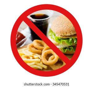 Fast Food, Low Carb Diet, Fattening And Unhealthy Eating Concept - Close Up Of Hamburger Or Cheeseburger, Deep-fried Squid Rings And French Fries Behind No Symbol Or Circle-backslash Prohibition Sign