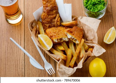 Fast food as a lunch meal. Eating with disposable cutlery. Dining at a fish and chips shop.