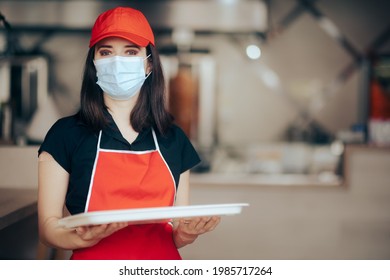 Fast Food Restaurant Worker Wearing Face Mask Holding A Tray. Female Employee In The Food Service Industry Showing Vaccinated Arm
