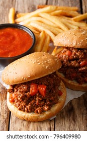 Fast Food: Sandwich Sloppy Joe With Tomato Sauce And Fries Close-up On The Table. Vertical
