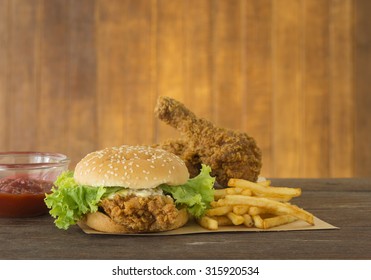 fast food set hamburger and french fries with fried chicken on wood background. - Powered by Shutterstock