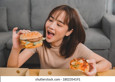 Fast Food Takeaway Back Home. Eating Burger When Takeout And Delivery. Asian Woman Lifestyle In Living Room. Social Distancing And New Normal.