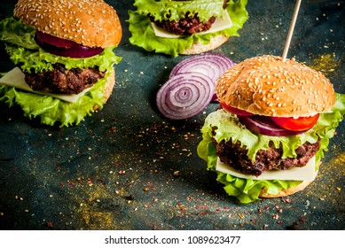 Fast Food. Unhealthy Food. Delicious Fresh Tasty Burgers With Beef Cutlet, Fresh Vegetables And Cheese On Dark Blue Concrete Background. Copy Space 