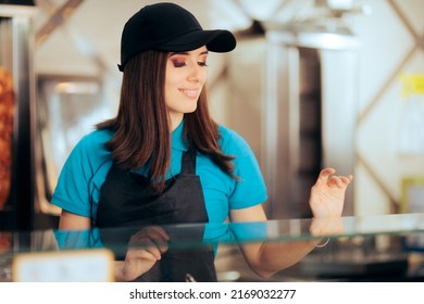 
Fast Food Vendor Smiling From Behind The Counter. Restaurant Employee Working Serving Customers
