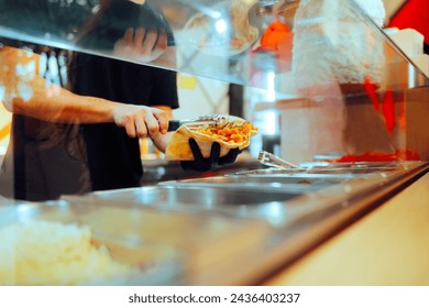 
Fast food Worker Assembling a Flat bread Sandwich in a Restaurant. Cook working in a diner making middle eastern street food
 - Powered by Shutterstock