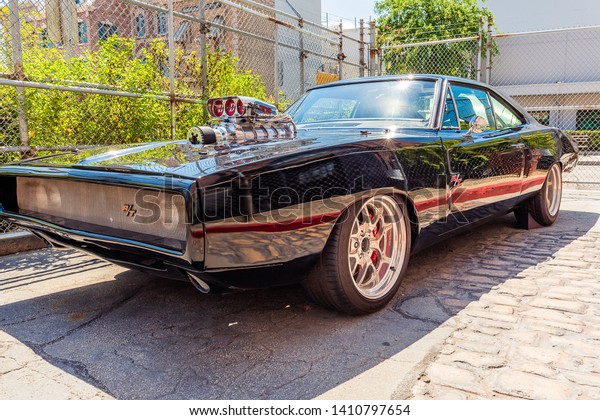 Fast\
and Furious dodge charger black shiny sports car with lots of\
chrome was from a movie and is roped off outside the movies ride at\
Universal Studios Orlando Florida on March 24\
2019
