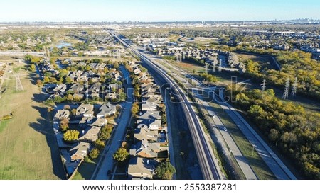 Fast growing mixed-use development area with residential houses, light rail system, precast concrete walls noise barrier along Belt Line Road suburbs Dallas, sound mitigation city quiet zones. USA
