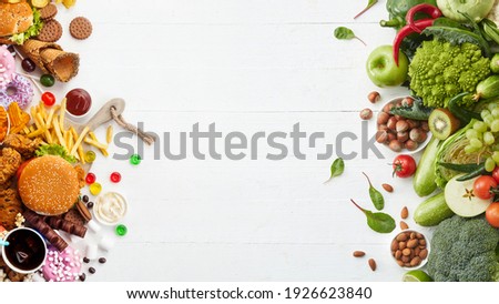 Fast and healthy food compared on white background. Unhealthy set of burgers, sauces, french fries in comparison with set of vegetables, fruits, organic green avocado, cabbage, nuts, citruses.
