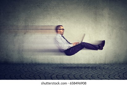 Fast Internet Concept. Levitating Business Man On Road Using Laptop Computer
