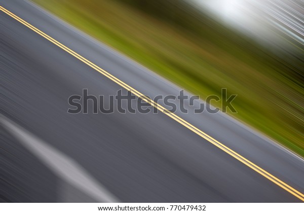 The fast lane. Image\
of asphalt highway tilted and added motion blur effect. Emphasize\
speed and motion.