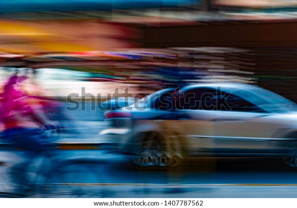 fast moving
/motion of a blurry  car and a bicycle on the road. Long exposure
and slow shutter speed
explained.