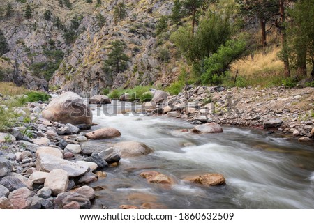 A fast moving stream with rocks and rapids on the Front Range of Colorado.  The Big Thompson River flows from the Rockies to the South Platte River, ending in the Mississippi River.