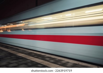 fast moving train in the evening whose speed is shown by motion blur 