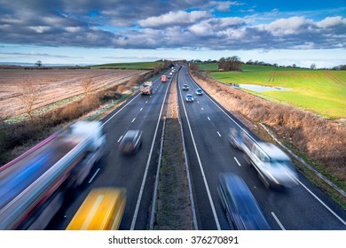 Fast Moving Vehicles On Busy Motorway At The Morning