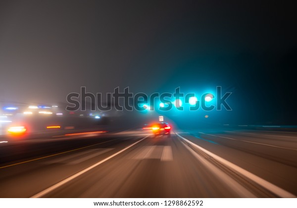 Fast\
night driving on highway, view from inside of a\
car