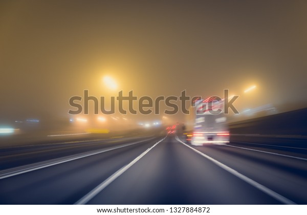 Fast\
night driving on highway, view from inside of a\
car