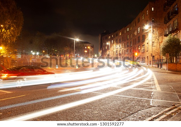 Fast paced city light trails at night time in\
Dublin Ireland