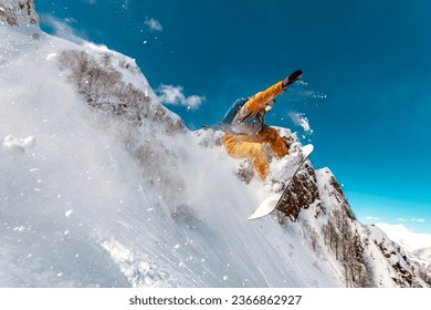 Fast professional snowboarder jumps at offpiste ski slope in cloud of powder snow - Powered by Shutterstock