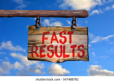 Fast results motivational phrase sign on old wood with blurred background