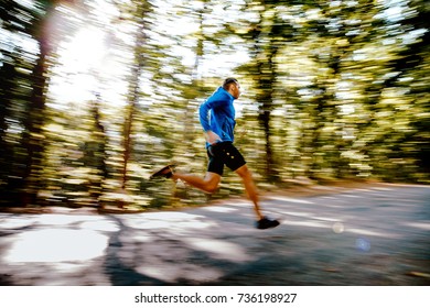 Fast Running Man Runner In Forest Road Blurred Motion