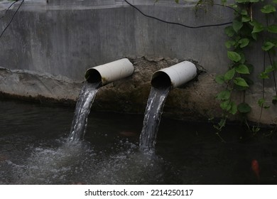 Fast Shutter Image On A Fish Pond Water Drainage Pipe