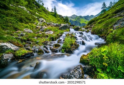 A fast stream among the mountain hills. Mountain river stream flowing. River stream in mountains. River stream flow