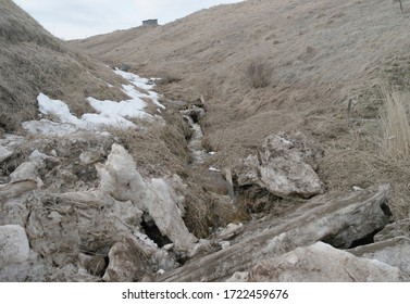 fast stream flowing down the mountain gorge into the river after the snow melts