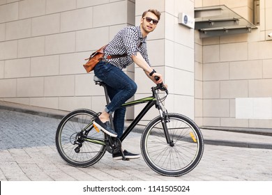 Fast Vehicle. Smart Handsome Man Riding A Bike In The City While Going To Work In The Office