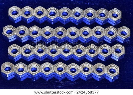 Fasteners - a background of a large number of nuts. Connecting parts.