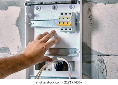 Fastening Circuit Breakers On DIN Rail Mounting When Installing Electrical Panel Consumer Unit Of Distribution Board Or Switchboard.