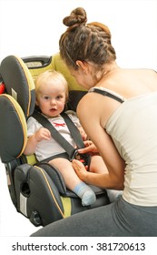 Fastens The Baby Car Seat In The Mother. The Baby Is Crying