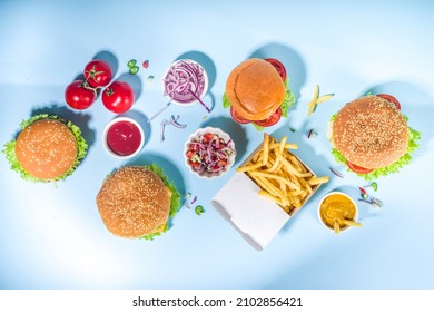 Fastfood, Burger Party Concept. Various Delicious Burgers Set With French Fries And Sauces On Bright Blue Background Flatlay Top View Copy Space