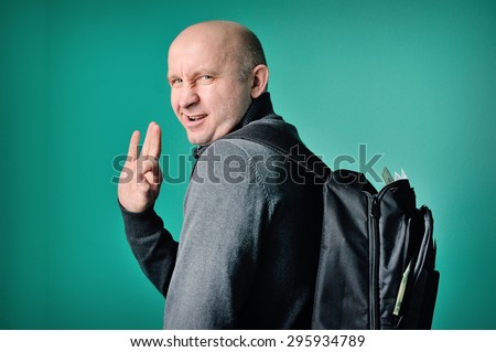 fastidious man with a backpack in studio