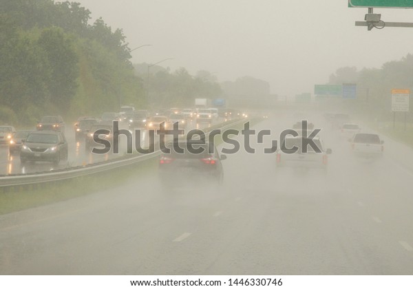 Fast-moving cars kick\
up clouds of  moisture during a rainstorm over Route 50 E in Anne\
Arundal County,\
Maryland.