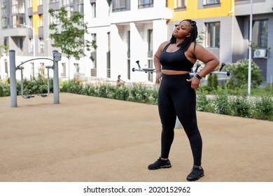 Fat Afro American Woman Warming Up Body Before Outdoor Running. Getting Ready For Jogging. Sport, Activity, Healthy Lifestyle And Weight Loss. Side View Portrait, Copy Space